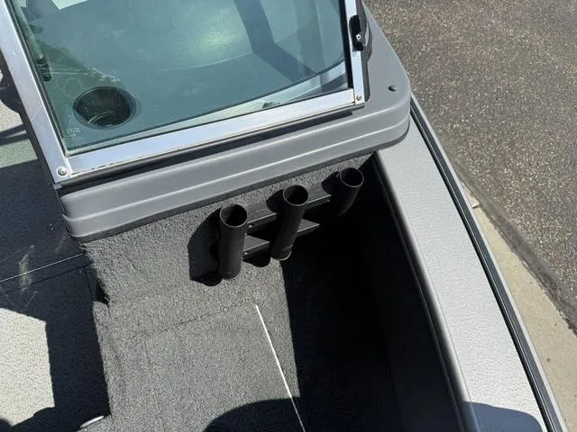 Slide: The Image of 2012 Lund 1750 Tyee boat interior with rod holders and windshield detail. - 23