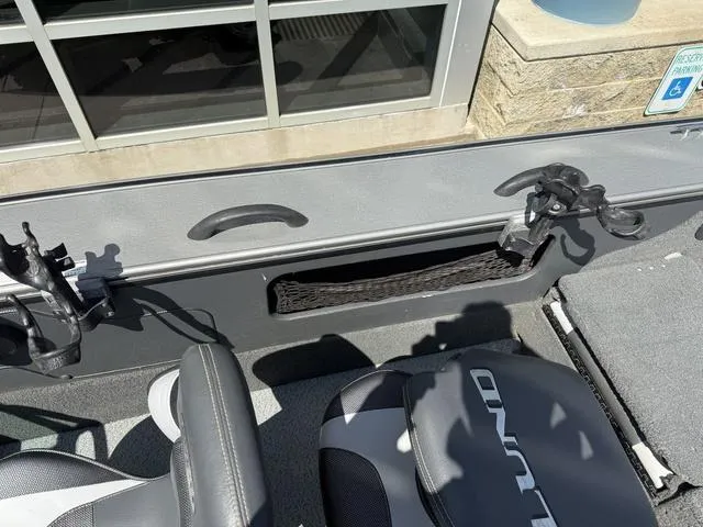Slide: The Image of Interior of a 2012 Lund 1750 Tyee boat with seating and rod holders. - 25