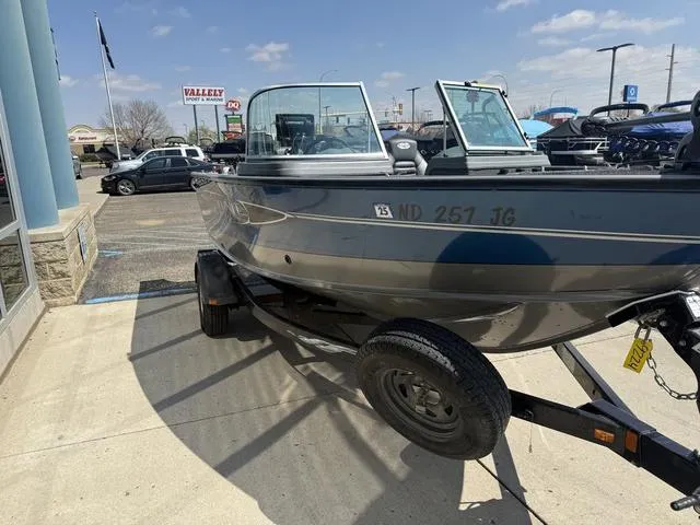 Slide: The Image of 2012 Lund 1750 Tyee boat on trailer in parking lot, sunny day. - 5