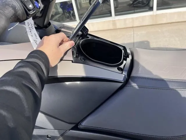 Slide: The Image of 2025 Yamaha Waverunner GP SVHO™ with Audio, storage compartment open, hand lifting lid. - 13