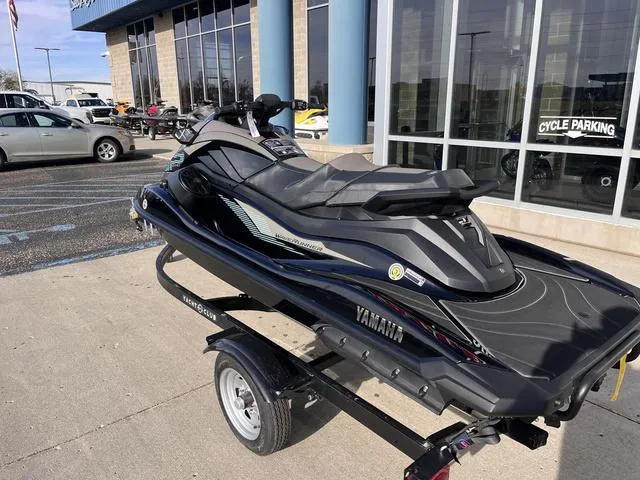 Slide: The Image of 2025 Yamaha Waverunner GP SVHO™ with Audio on trailer, parked outside a dealership. - 3
