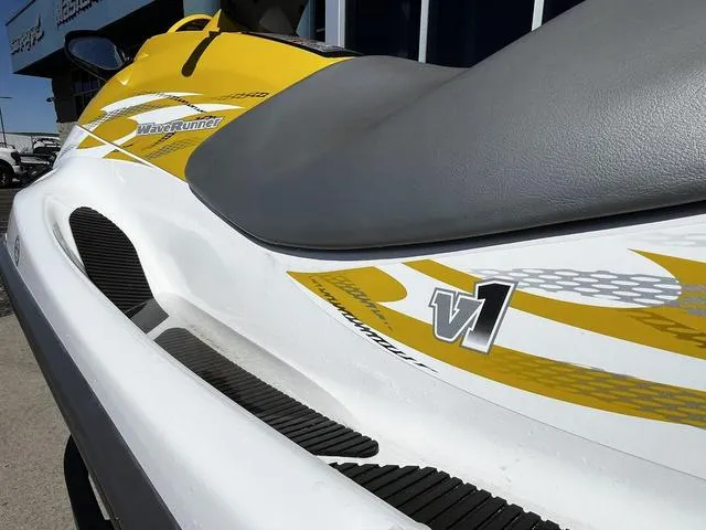 Slide: The Image of 2015 Yamaha WaveRunner V1 jet ski with yellow and white design, side view. - 18