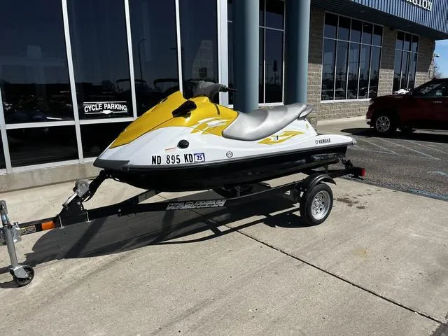 Slide: The Image of 2015 Yamaha WaveRunner V1 jet ski on trailer, parked outside a building. - 3