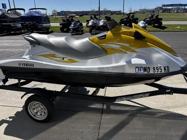 Slide: The Image of 2015 Yamaha WaveRunner V1 jet ski on trailer, yellow and white design, parked outdoors. - 9