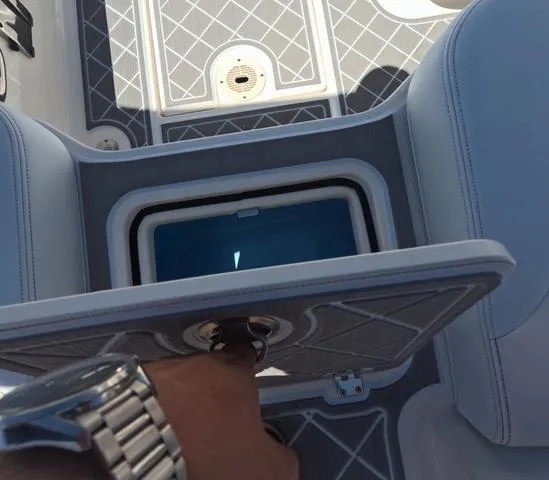 Slide: The Image of 2019 Chaparral 191 Suncoast boat interior with storage compartment open. - 16