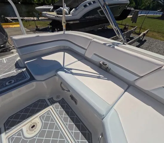 Slide: The Image of 2019 Chaparral 191 Suncoast boat interior with white seating and gray flooring. - 18