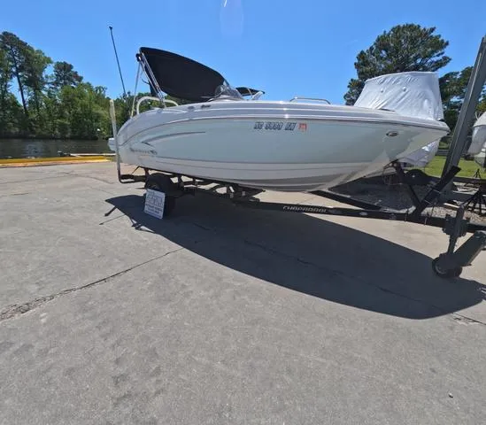 Slide: The Image of 2019 Chaparral 191 Suncoast boat on trailer, parked outdoors on a sunny day. - 2