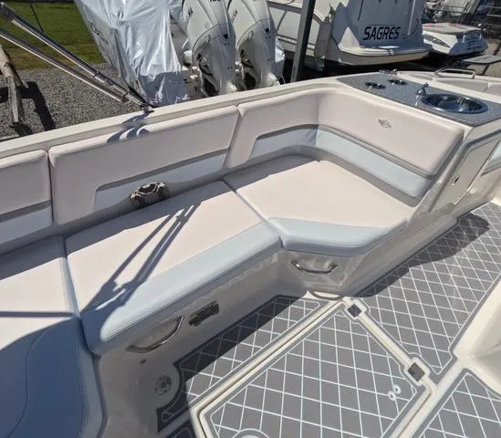 Slide: The Image of 2019 Chaparral 191 Suncoast boat interior with cushioned seating and patterned flooring. - 20