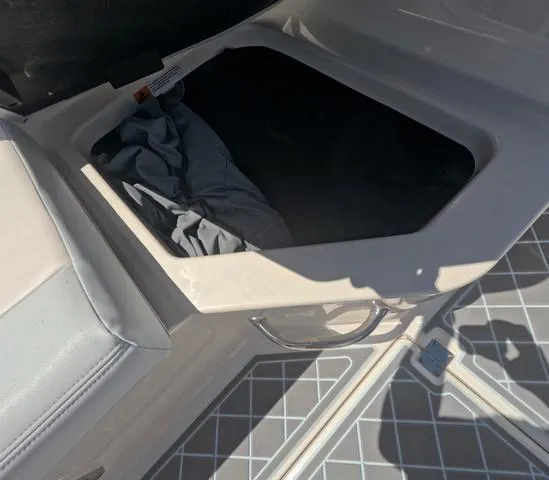 Slide: The Image of Storage compartment on 2019 Chaparral 191 Suncoast boat with gray fabric inside. - 22