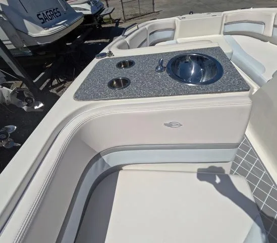 Slide: The Image of 2019 Chaparral 191 Suncoast boat interior with sink and seating area. - 23