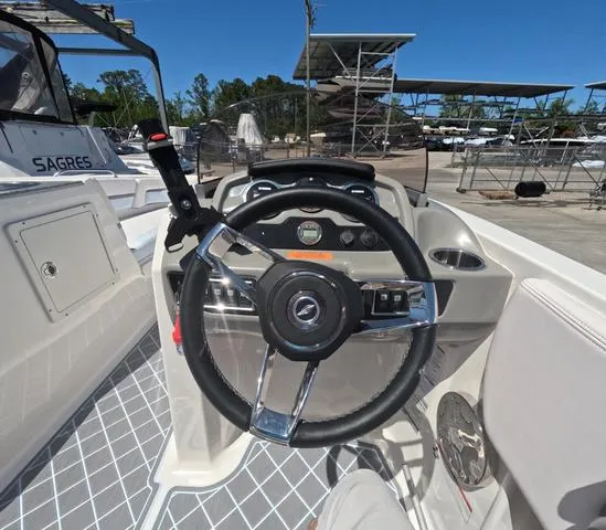 Slide: The Image of 2019 Chaparral 191 Suncoast boat cockpit with steering wheel and control panel. - 25