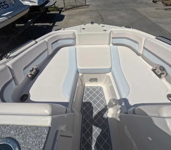 Slide: The Image of 2019 Chaparral 191 Suncoast boat interior with cushioned seating and storage compartments. - 31