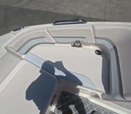 Slide: The Image of 2019 Chaparral 191 Suncoast boat interior with cushioned seating and cup holder. - 32