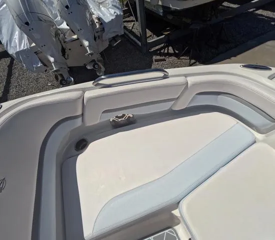 Slide: The Image of 2019 Chaparral 191 Suncoast boat interior with cushioned seating and storage area. - 33
