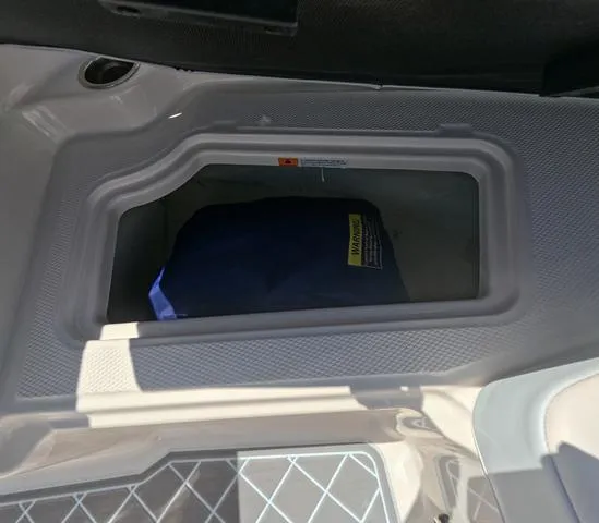 Slide: The Image of Storage compartment in 2019 Chaparral 191 Suncoast boat, featuring a blue cover inside. - 34