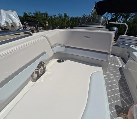 Slide: The Image of 2019 Chaparral 191 Suncoast boat interior with white seating and cup holder. - 40