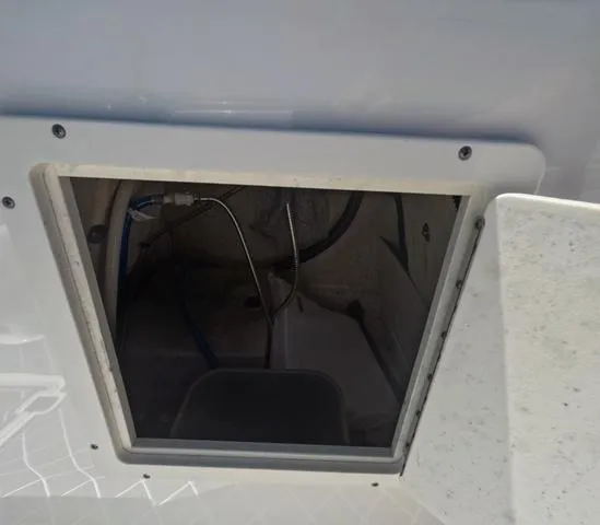 Slide: The Image of Storage compartment of a 2019 Chaparral 191 Suncoast boat, showing interior wiring. - 42