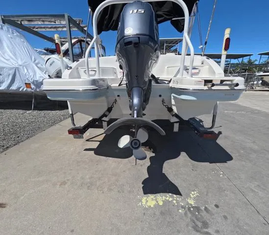 Slide: The Image of 2019 Chaparral 191 Suncoast boat rear view with outboard motor in marina. - 7