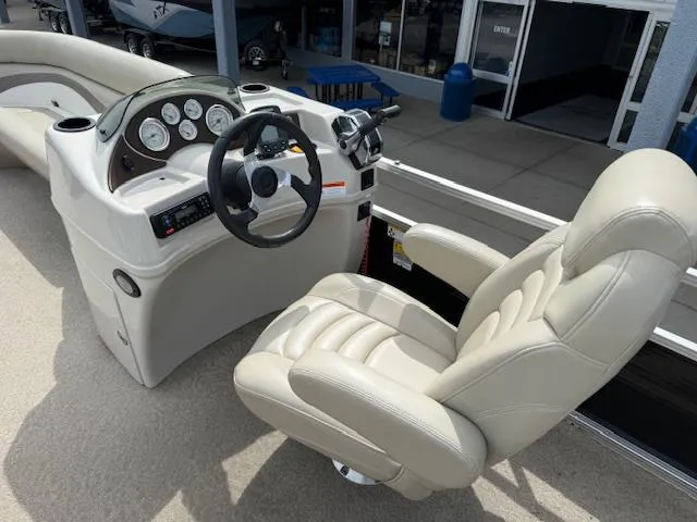 Slide: The Image of Luxurious 2012 Lowe SS250 boat interior with plush captain's chair and modern dashboard controls. - 10