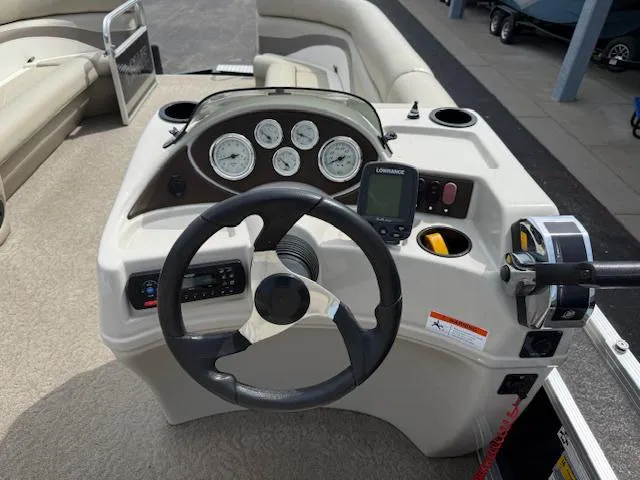 Slide: The Image of Steering console of a 2012 Lowe SS250 boat with gauges and navigation equipment. - 11