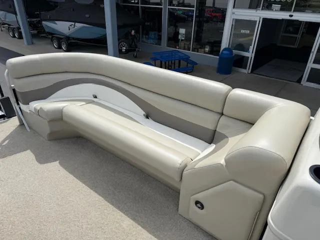 Slide: The Image of 2012 Lowe SS250 boat seating with beige and white upholstery, displayed outdoors. - 15