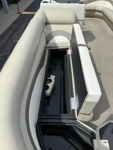 Slide: The Image of 2012 Lowe SS250 boat interior with open storage compartment and beige seating. - 17