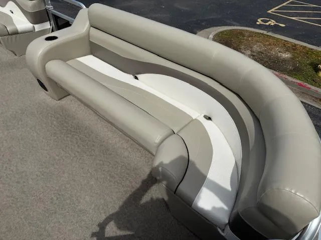 Slide: The Image of 2012 Lowe SS250 boat interior with beige seating and cup holder. - 18