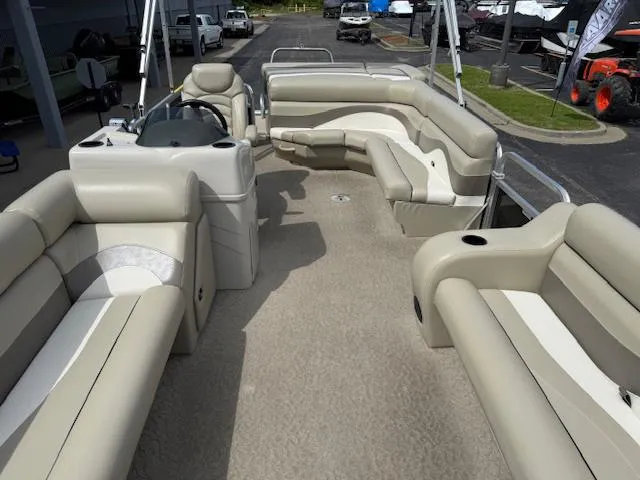 Slide: The Image of 2012 Lowe SS250 pontoon boat interior with beige seating and steering console. - 20