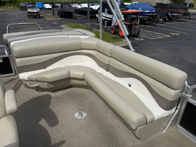 Slide: The Image of 2012 Lowe SS250 boat with beige and white seating in a parking lot. - 21