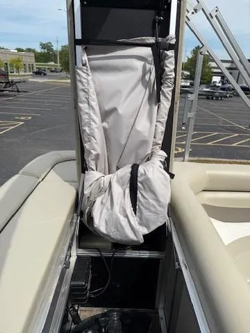 Slide: The Image of 2012 Lowe SS250 boat interior with storage compartment and cover in a parking lot. - 22