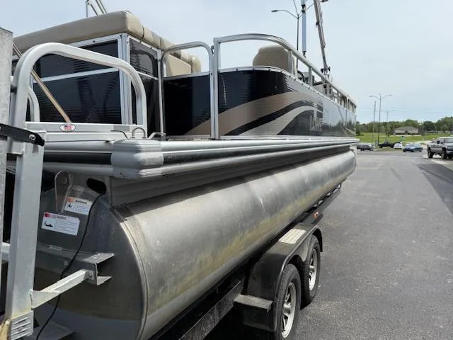 Slide: The Image of 2012 Lowe SS250 pontoon boat on trailer, parked on asphalt. - 3