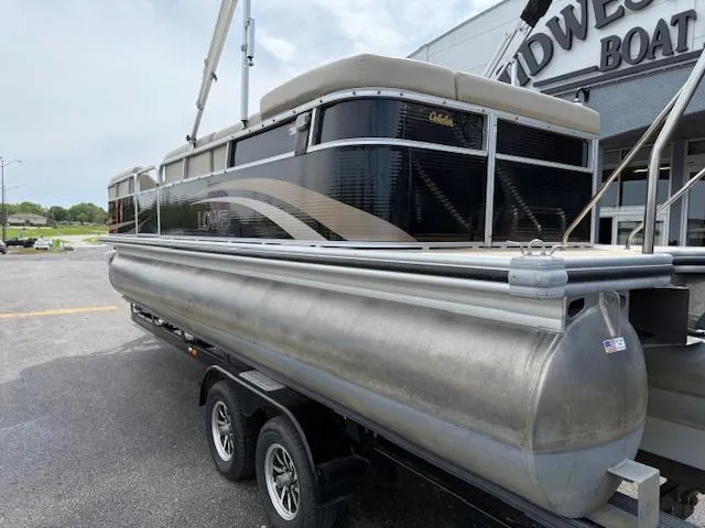 Slide: The Image of 2012 Lowe SS250 pontoon boat on trailer outside dealership. - 5