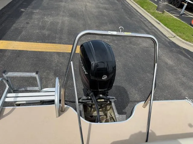 Slide: The Image of 2012 Lowe SS250 boat with Mercury outboard motor, parked on asphalt. - 7