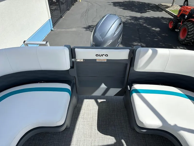 Slide: The Image of 2025 Aura Quad Lounge boat interior with modern seating and outboard motor. - 11