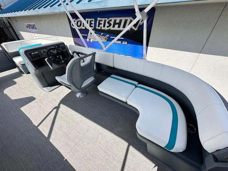 Slide: The Image of 2025 Aura Quad Lounge boat interior with modern seating and steering console. - 14