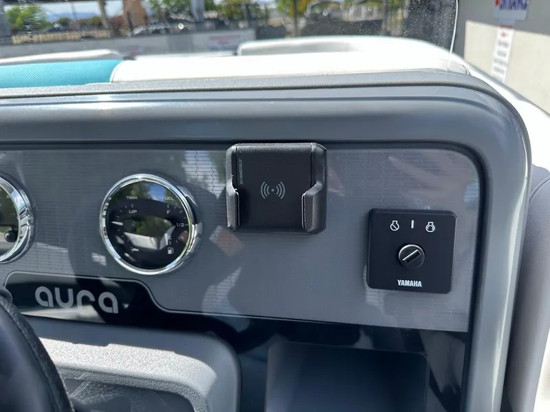 Slide: The Image of Dashboard of 2025 Aura Quad Lounge with Yamaha controls and wireless charging pad. - 19