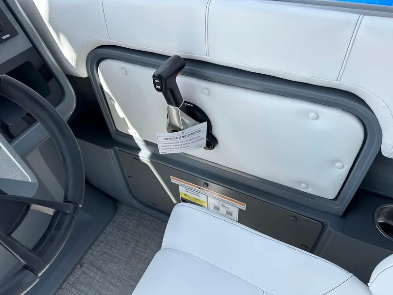 Slide: The Image of Interior of 2025 Aura Quad Lounge boat with steering wheel and control lever. - 20