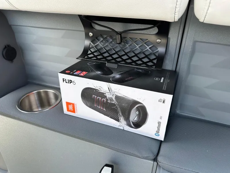 Slide: The Image of A JBL Flip 6 speaker box inside a 2025 Aura Quad Lounge boat compartment. - 21