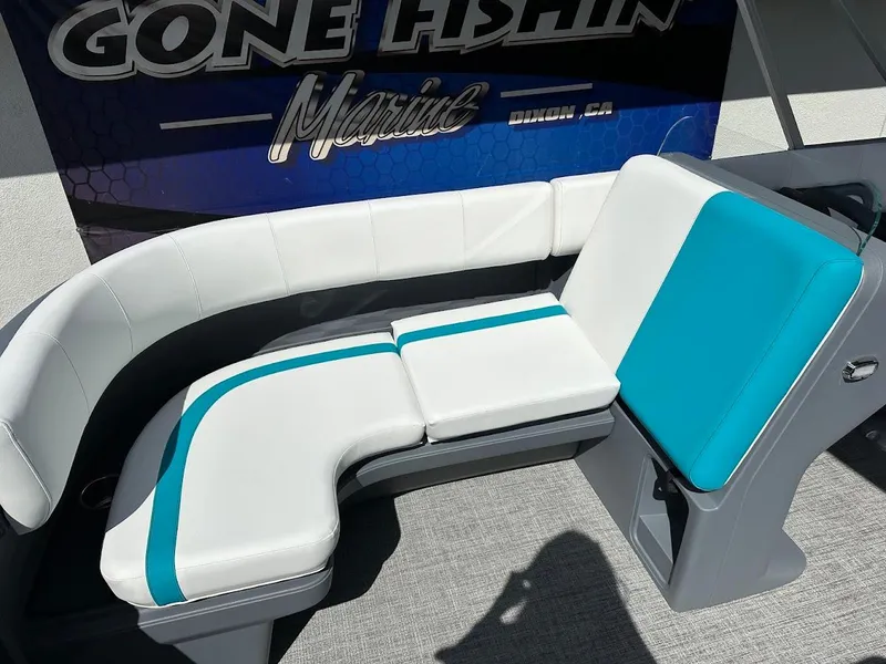 Slide: The Image of 2025 Aura Quad Lounge boat seating with white and teal upholstery. - 23