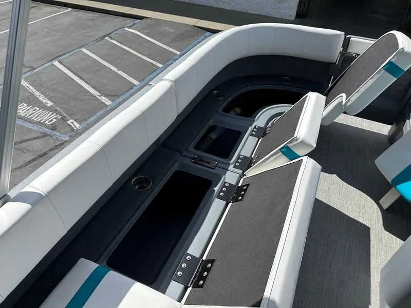 Slide: The Image of 2025 Aura Quad Lounge boat interior with spacious seating and storage compartments. - 26