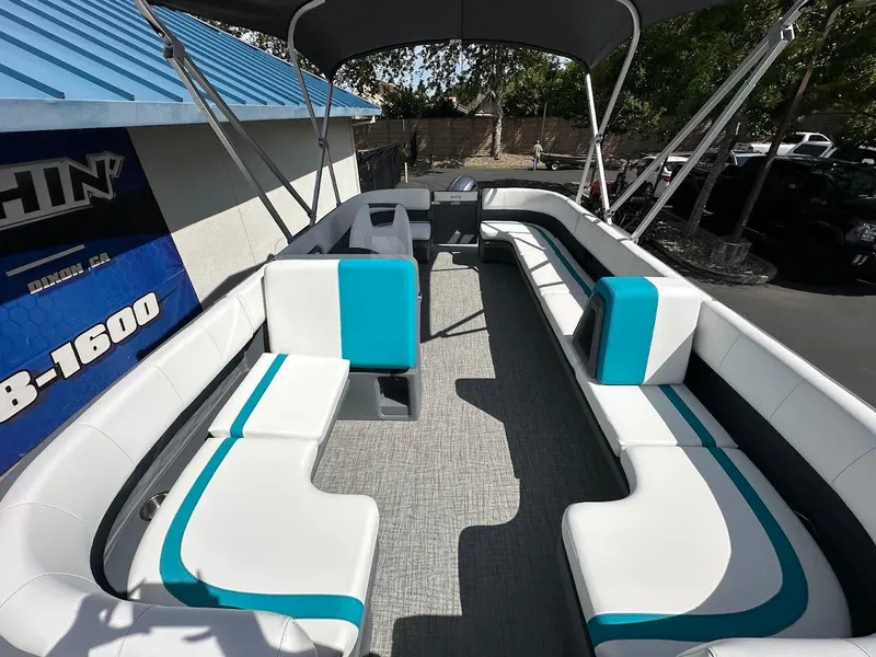Slide: The Image of 2025 Aura Quad Lounge boat with spacious seating and modern design under a canopy. - 6