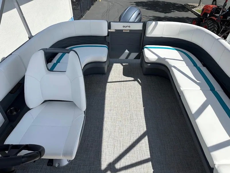 Slide: The Image of 2025 Aura Quad Lounge boat interior with white and blue seating, modern design. - 9