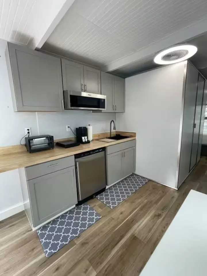 Slide: The Image of Modern kitchen with gray cabinets, wood countertops, and stainless steel appliances, in a 2023 Modern Struktures MS 360. - 10