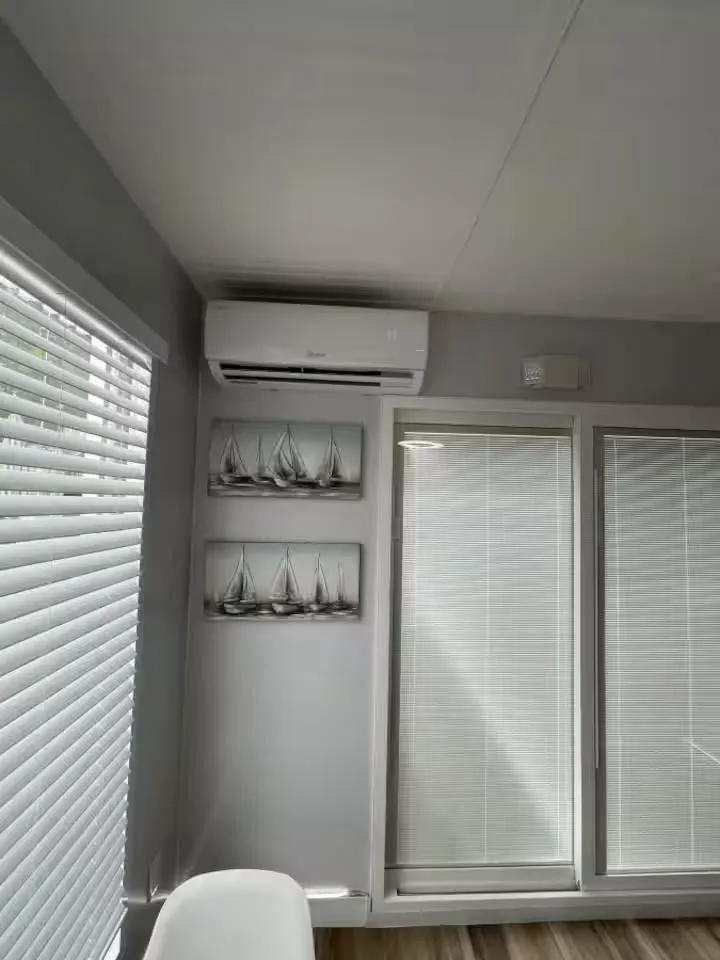 Slide: The Image of Modern living room with air conditioner, blinds, and sailboat artwork, featuring Modern Struktures MS 360. - 16