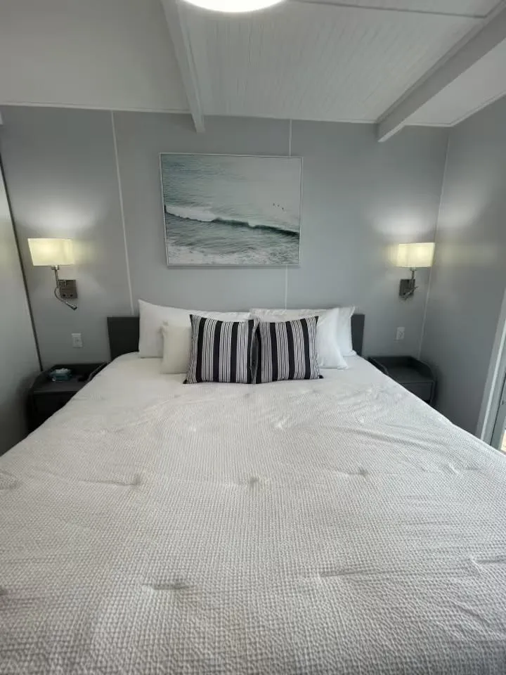 Slide: The Image of Modern bedroom with white bedding, abstract wall art, and ambient lighting, in a 2023 Modern Struktures MS 360. - 17