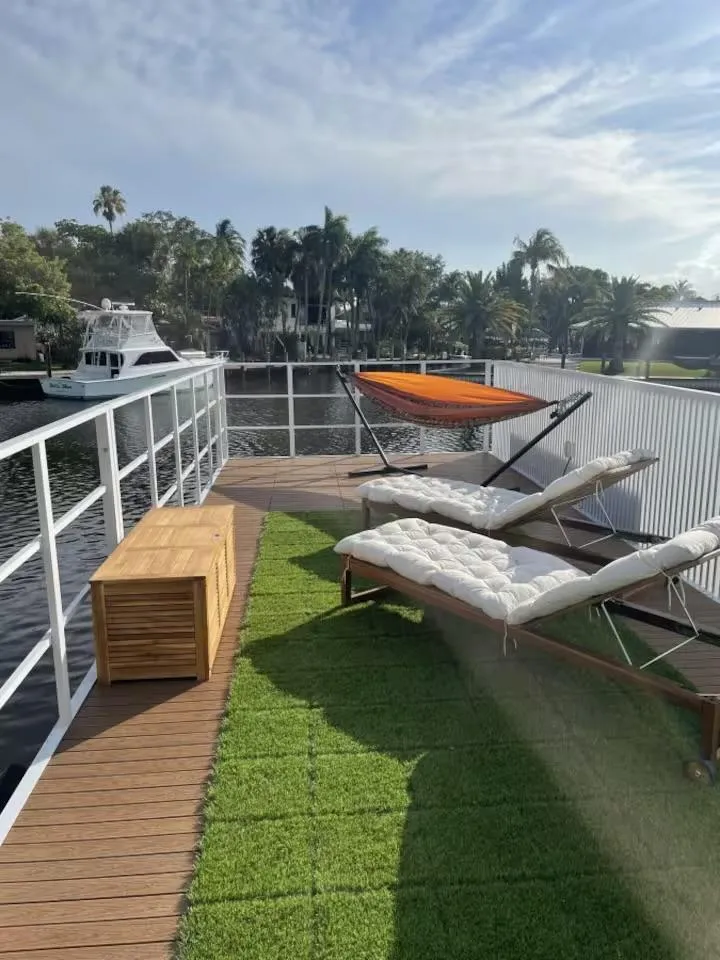 Slide: The Image of Modern Struktures MS 360 deck with loungers, hammock, and waterfront view, 2023 model. - 6