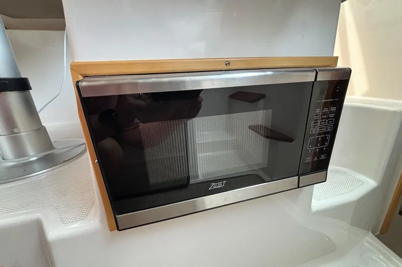 Slide: The Image of Microwave oven inside 2022 Cutwater C-248 Coupe boat kitchen area. - 20