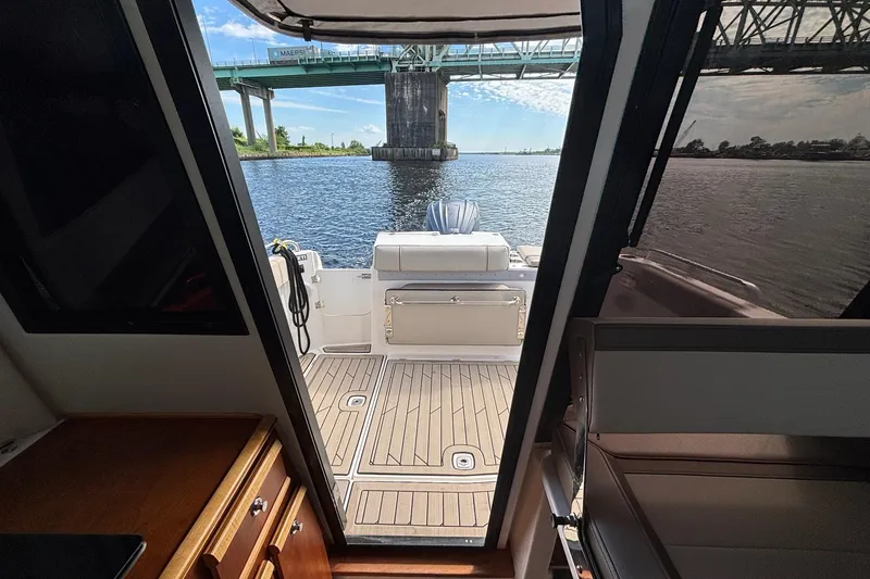 Slide: The Image of 2022 Cutwater C-248 Coupe interior view with open deck, bridge, and waterway. - 24