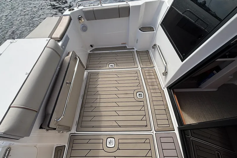 Slide: The Image of 2022 Cutwater C-248 Coupe boat deck with cushioned seating and wood-patterned flooring. - 27