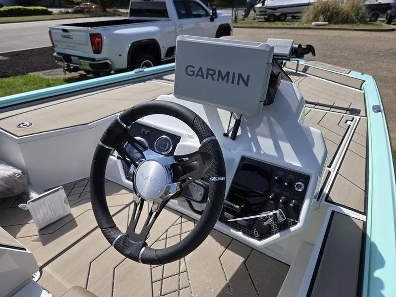Slide: The Image of 2025 Avid 18 Vertex boat dashboard with Garmin navigation system and steering wheel. - 12